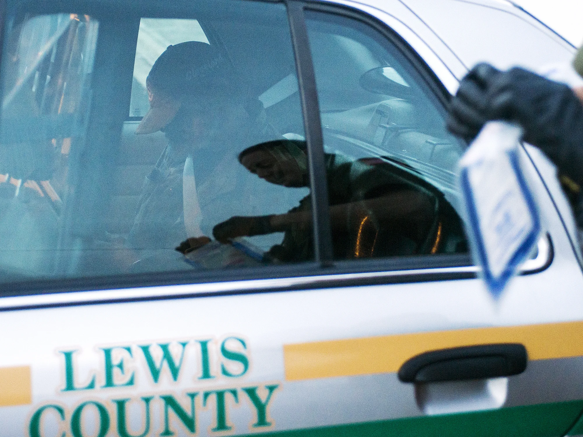  Richard A. Jacoby sits in the backseat of the patrol car as Lewis County Sheriff's Deputy Sue Shannon bags up the test results from a methamphetamine pipe that was found on Jacoby earlier in the evening after being arrested in Mineral. Shannon did t