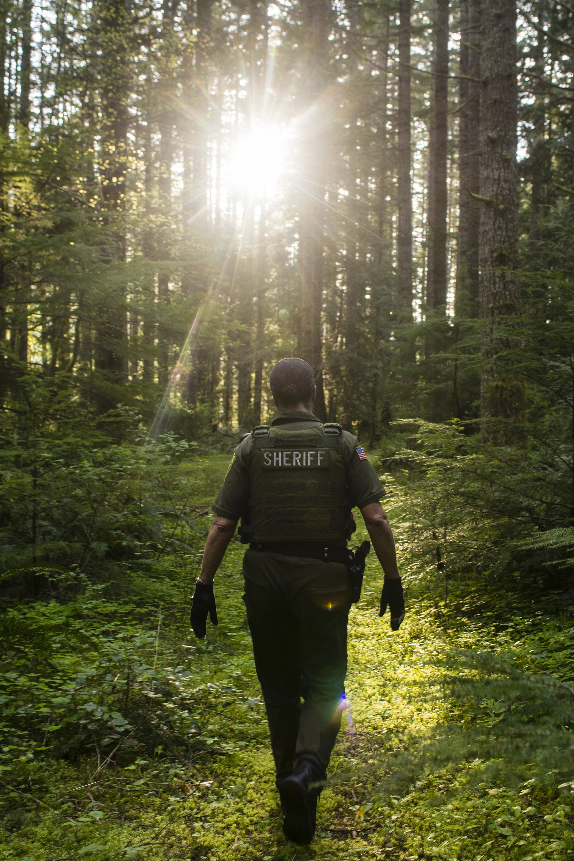  Lewis County Sheriff's Deputy Sue Shannon walks through the Pleasant Valley Wildlife Area towards Alder Lake where there was a report of over a dozen teenagers drinking along the shores. For 12 years Lewis County Sheriff's Deputy Shannon has patroll