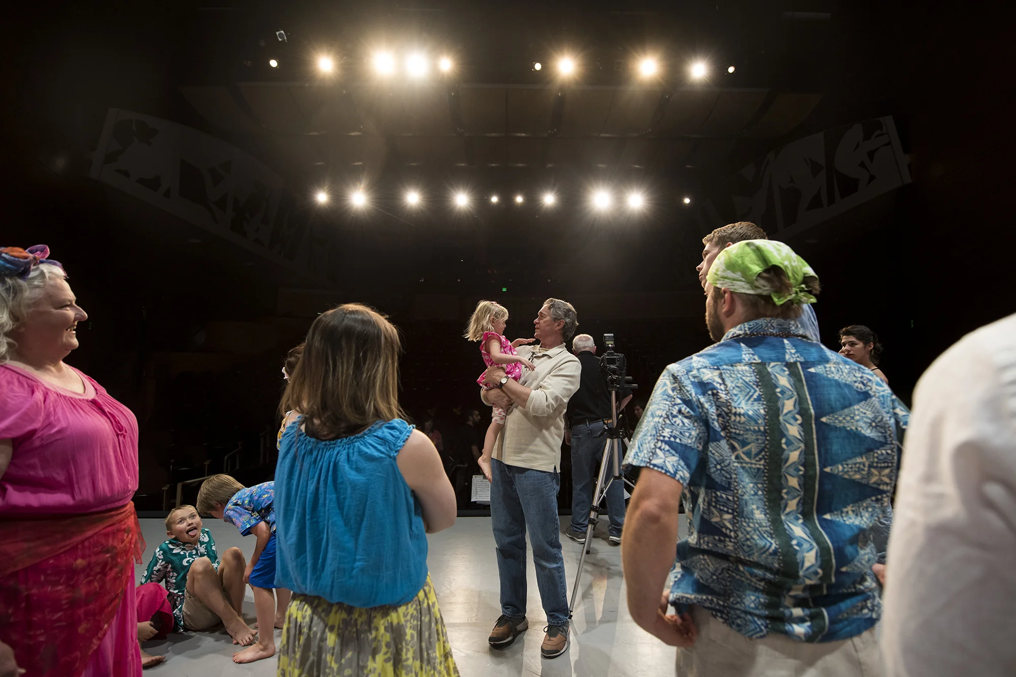  Longtime Centralia College drama professor Brian Tyrrell, center, holds Margaret Page, 3, the youngest actor in "Once on This Island", during a break in rehearsal on Monday, May 9 at Corbet Theatre in Centralia. This evening will play host to the la