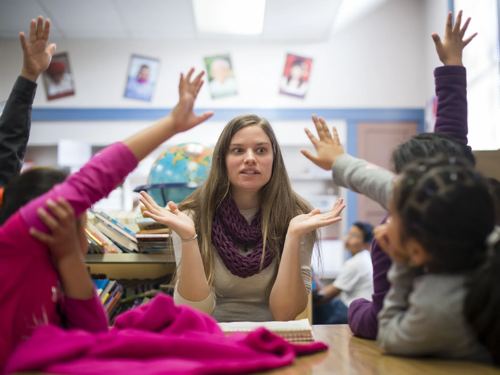 From left: Kimberly Ortiz, Angel Martinez, Ruvy Cruz and Lucia Hernandez raises their hands to answer a questions posed by Mossyrock Elementary School para-educator, Brenda Jones, center, during an English Language Learners class on Thursday morning.