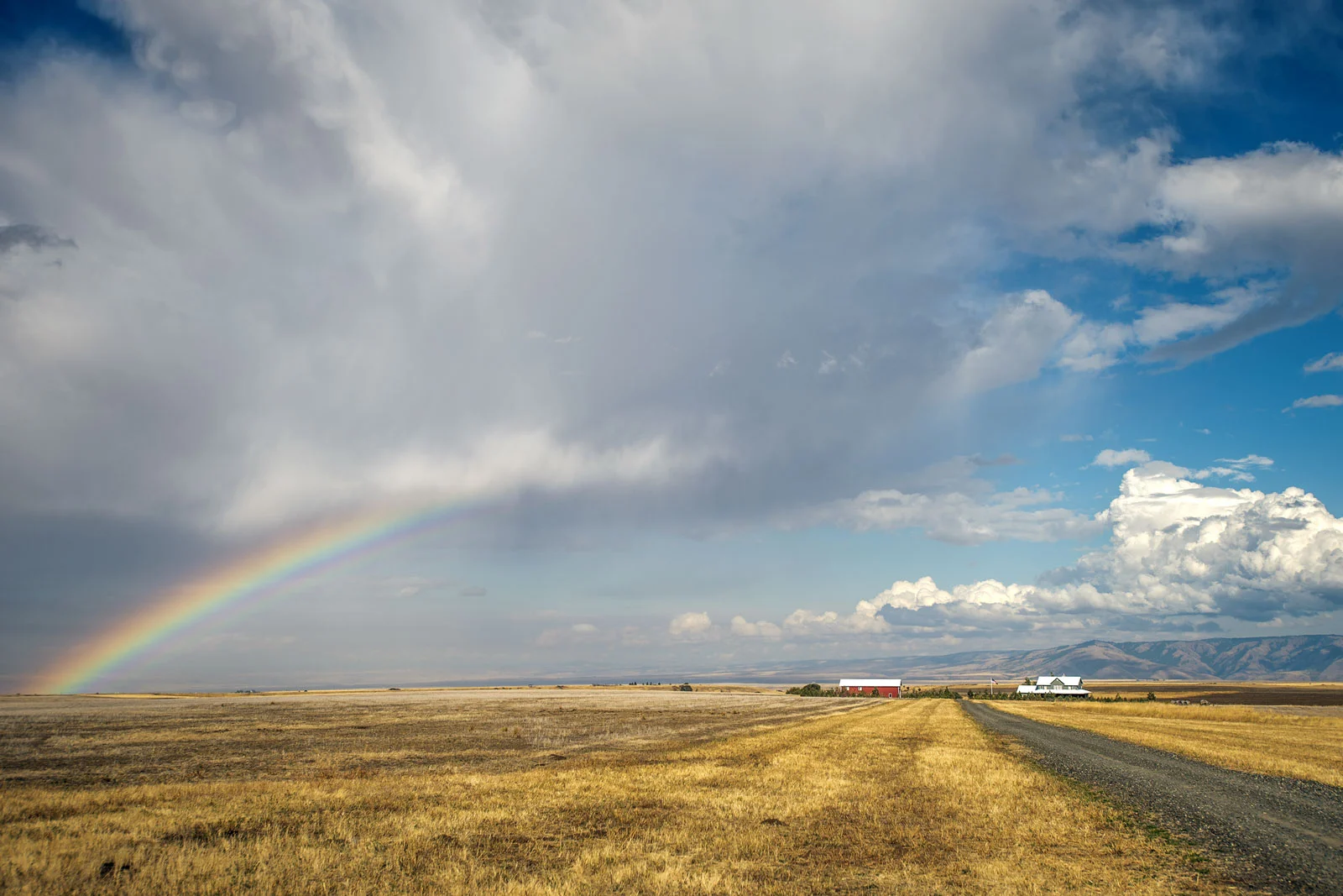 A small rain shower passing across the Lewiston-Clarkston Valley brings a rainbow along for the ride over the prairie north of Anatone, Wash., on Thursday, Sept. 13, 2018.