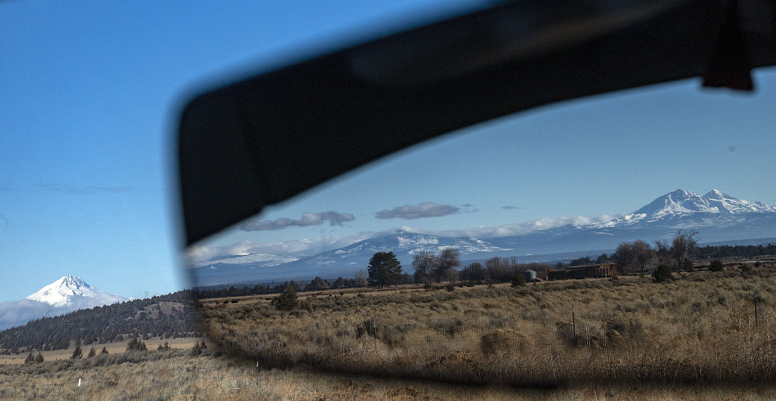  Three Sisters are seen in the rearview mirror while Mount Jefferson is seen to the west. 