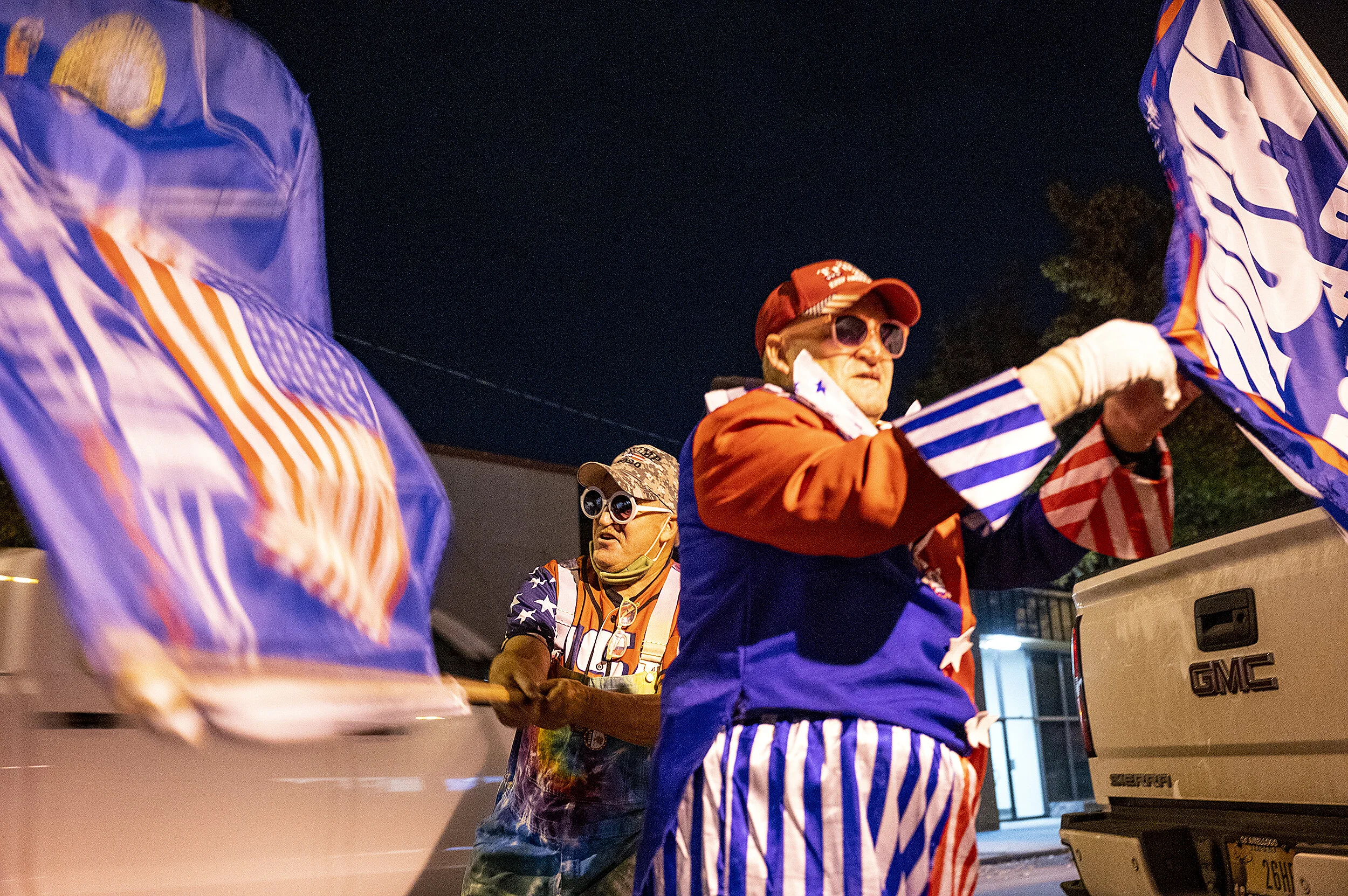  Kent Eberhardt, left, and his twin brother, Kurt, both of Lewiston, wave flags in support of President Donald Trump while standing outside their truck on Main Street in downtown Lewiston on Tuesday, Nov. 3, 2020. The brothers both wore their colorfu