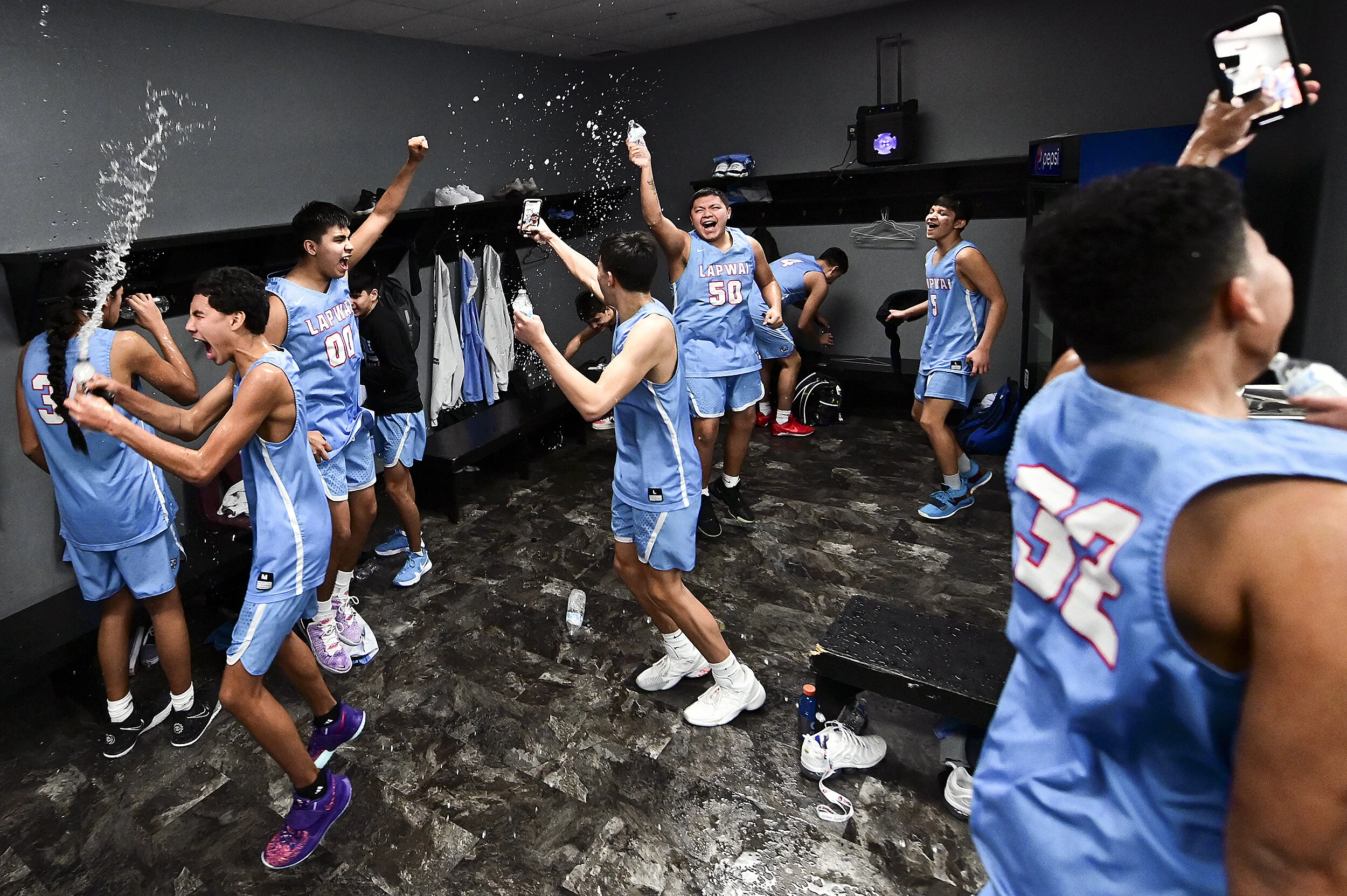  Lapwai players celebrate by spraying each other with water bottles in the locker room after beating Riverstone, 82-60, to win the Class 1A Division I state championship game on Friday, March 5, 2021, at the Idaho Center in Nampa, Idaho. 