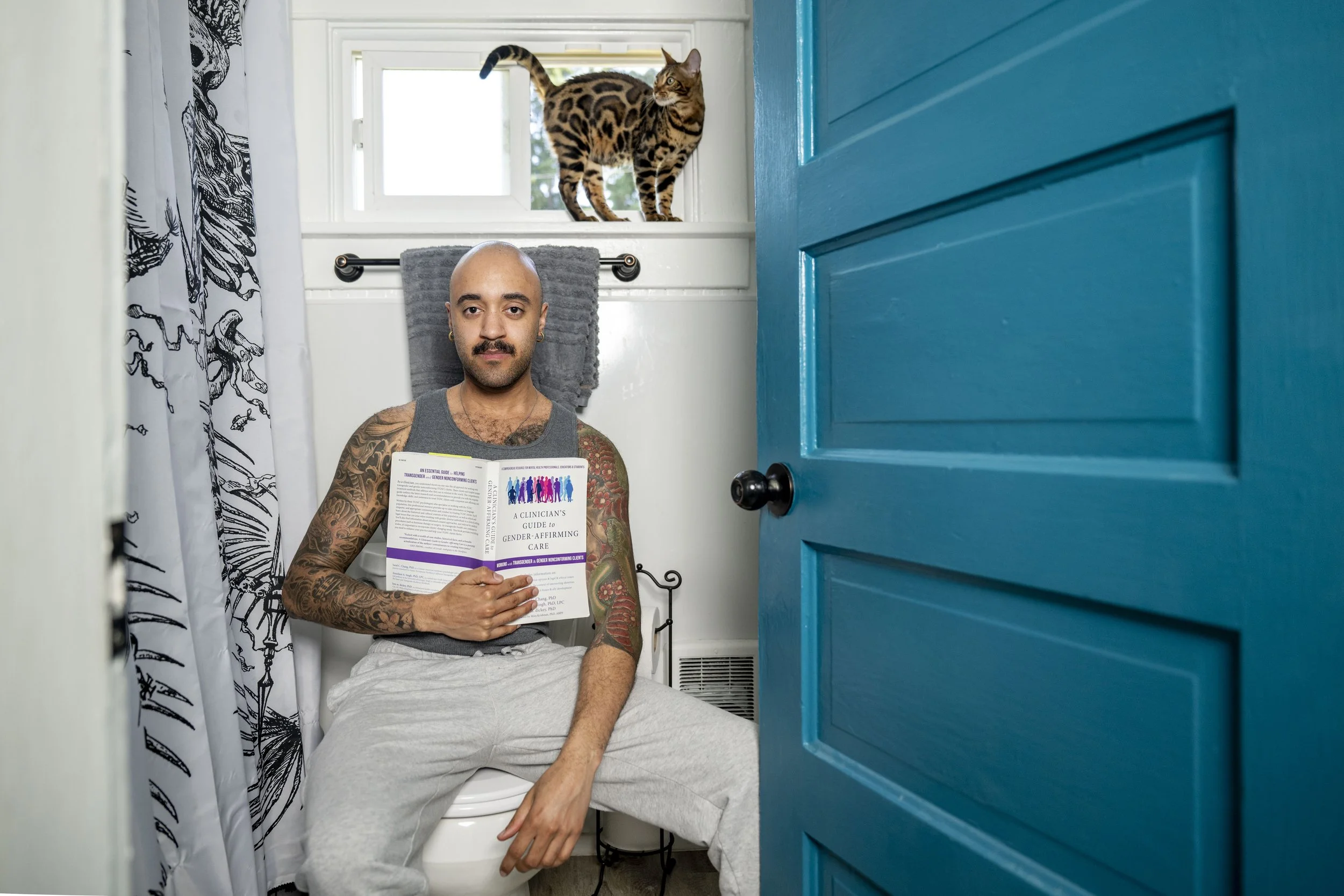  Scott Beck, 26, poses for a portrait while sitting on his toilet in what he says is the most comfortable room in the house for him — the bathroom — on Sunday, July 2, 2023, in Tacoma, Wash. 