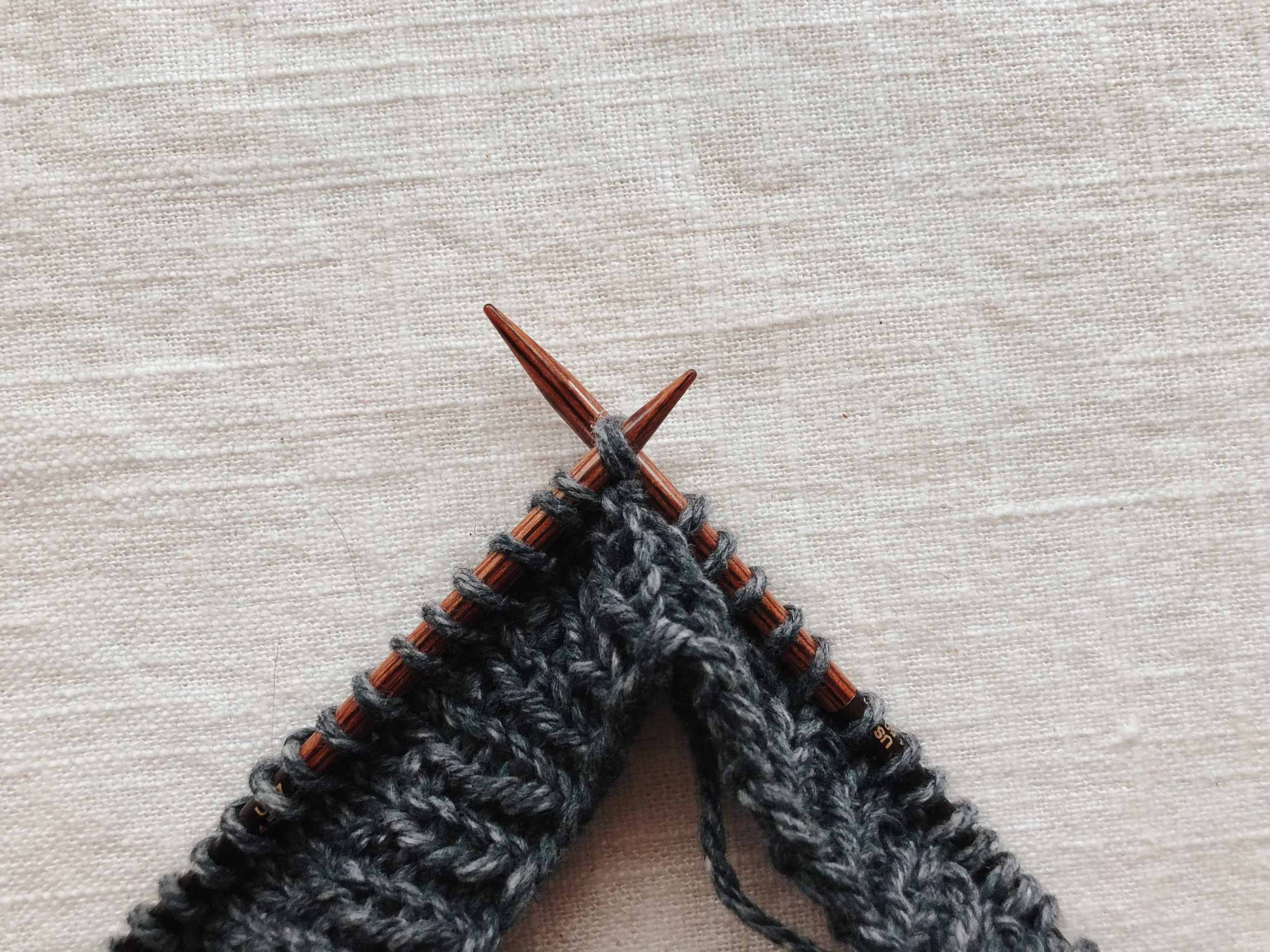 Transfer the two stitches back to the left needle and knit them together through the back.