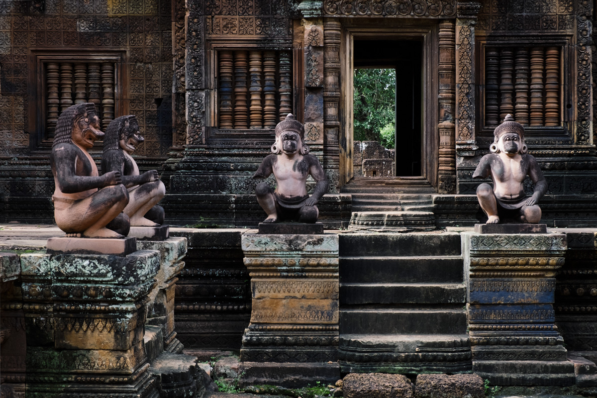 The intricate reliefs carving of red coloured stone. Banteay Srei Angkor Cambodia