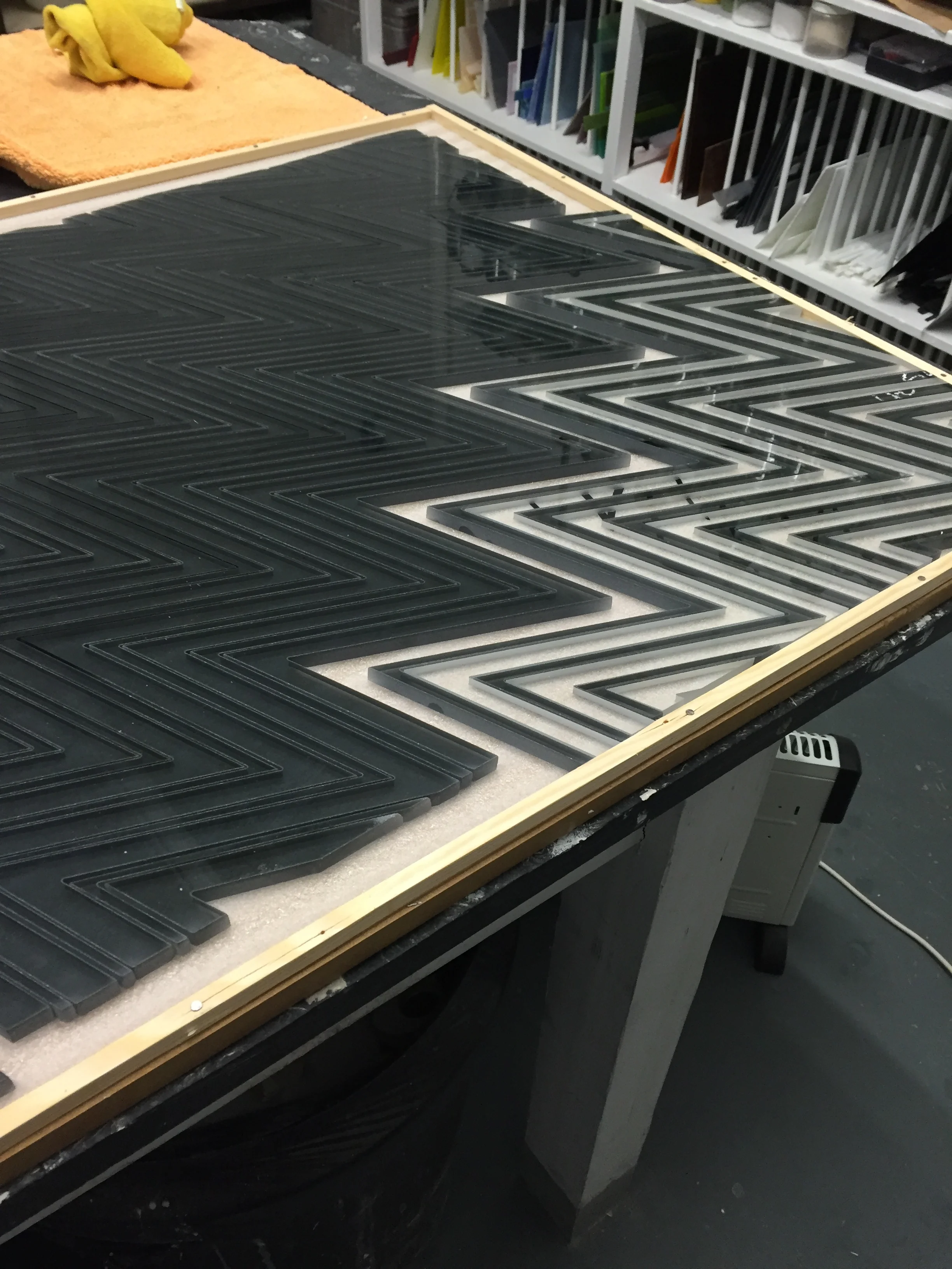 Once the strands are cut they are cleaned and laid onto a ceramic kiln shelf. The glass kiln is then fired to temperatures of around 800°C to fuse the individual strands together to form the glass tabletop.