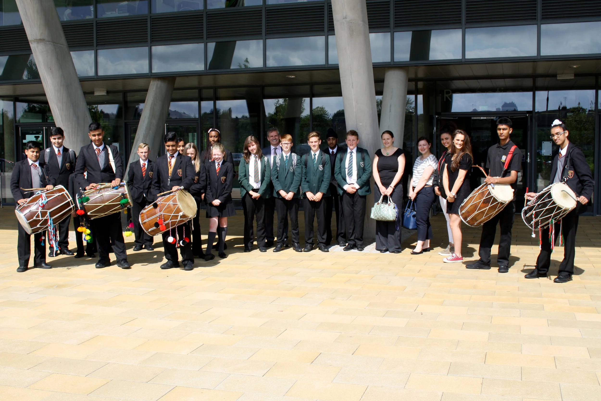 Photograph: Highfields' student guides, accompanied by Mr Jevon and a performance by our Dhol Drum group, greeted our visitors from Southam College.