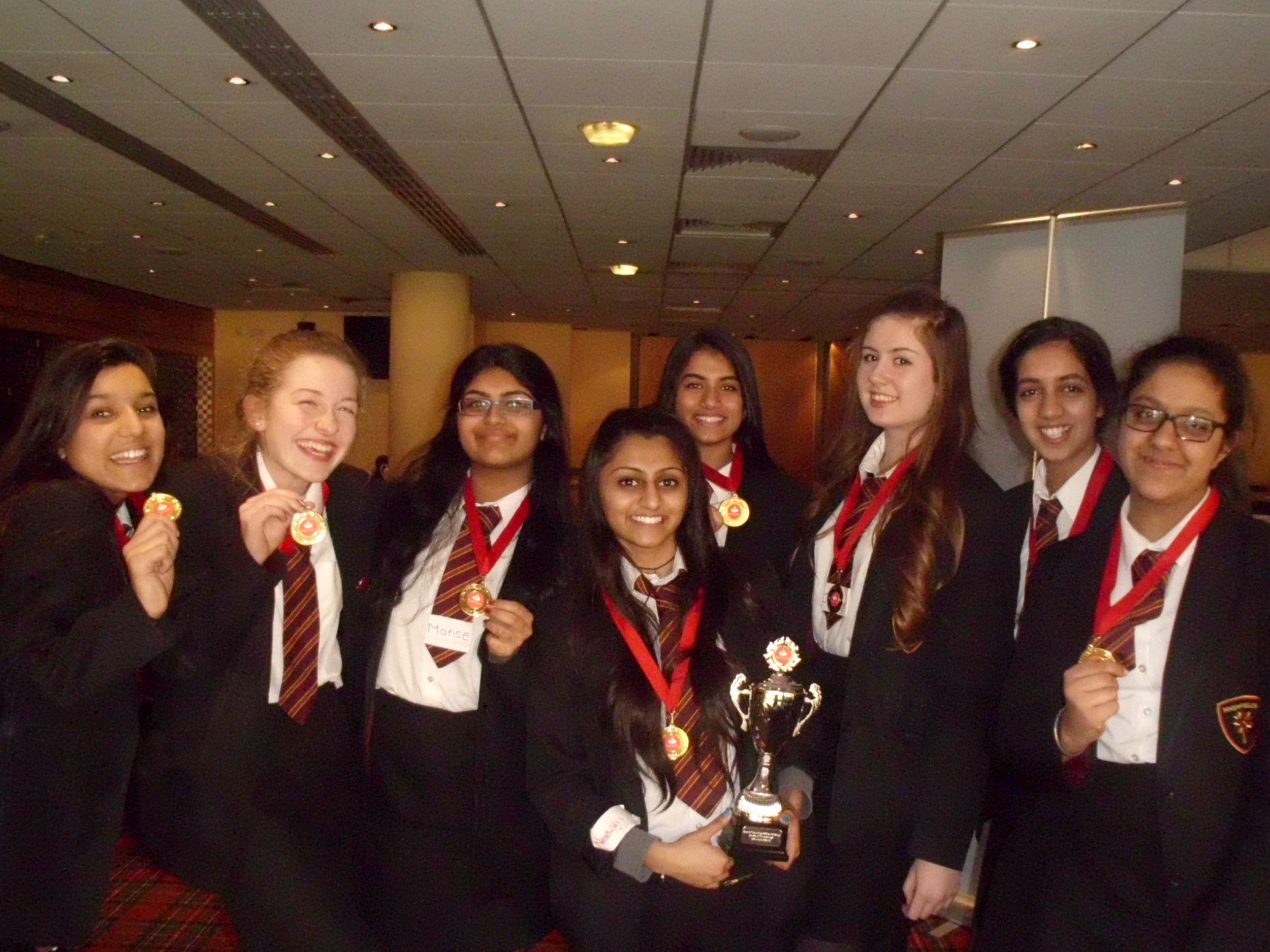 Students: Neelam Patel, Manse Jassi, Ellie White, Amnique Sidhu, Mishal Ishaq, Jordanne Farley-Moss, Jindveer Khangura, Harsimran Shuthar with their trophy and competition medals.