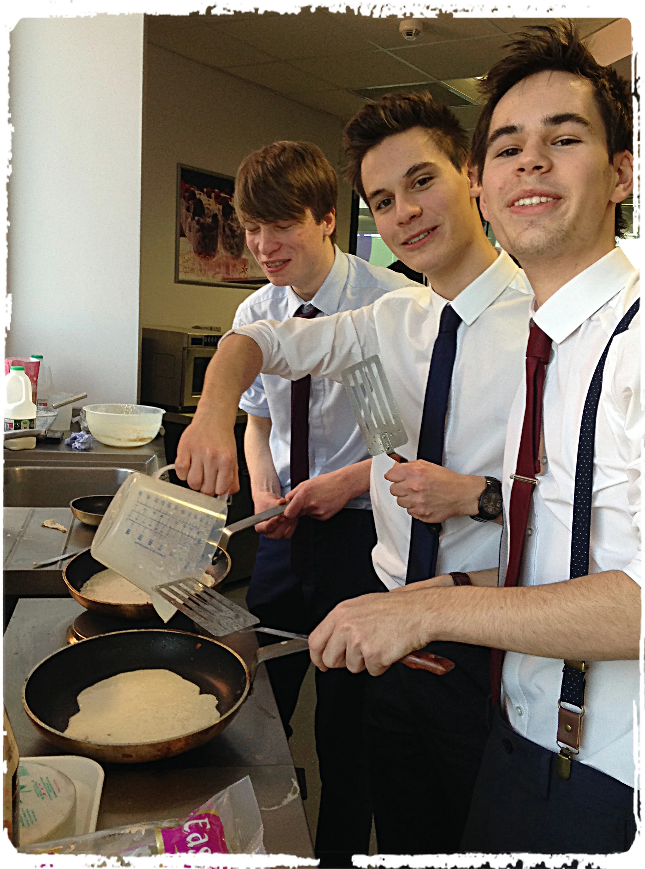 Students in a flip over pancakes