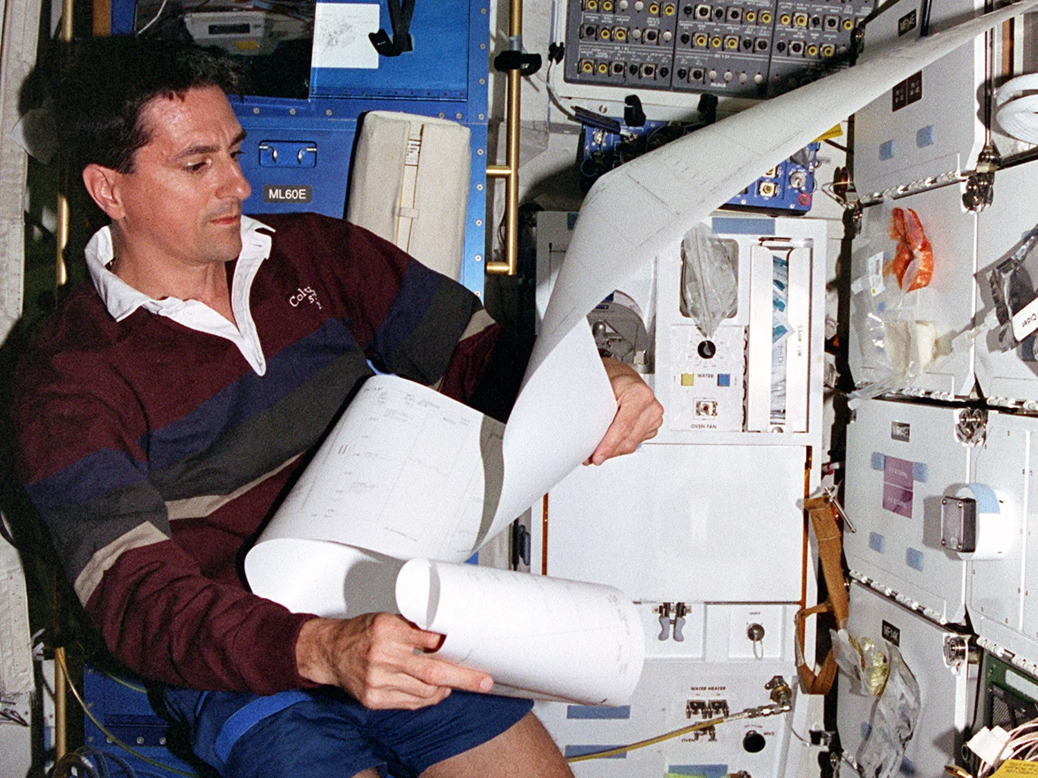Reviewing morning messages from Mission Control down in the middeck.