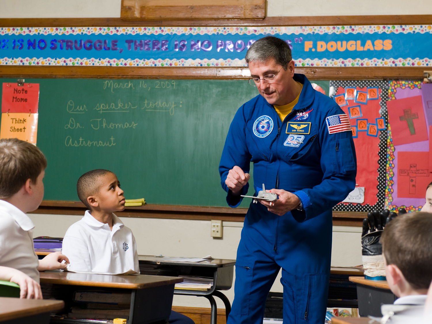  Eager group of future explorers learn details of the space shuttle. 