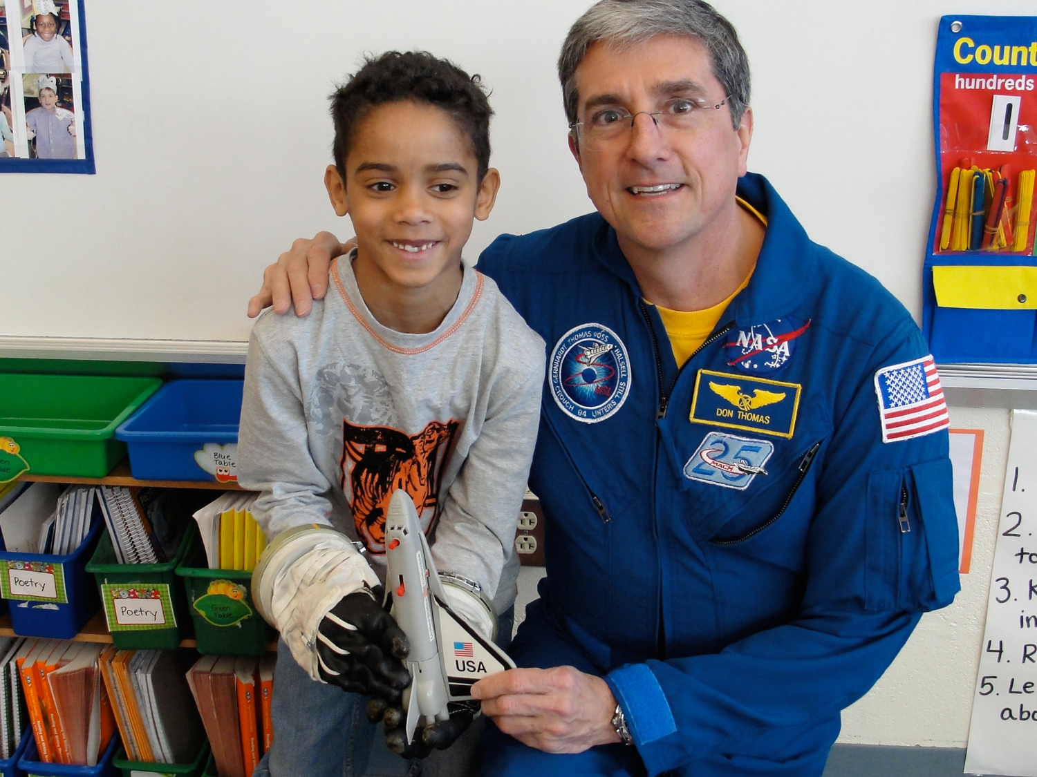  Trying on an actual space glove in the classroom. 