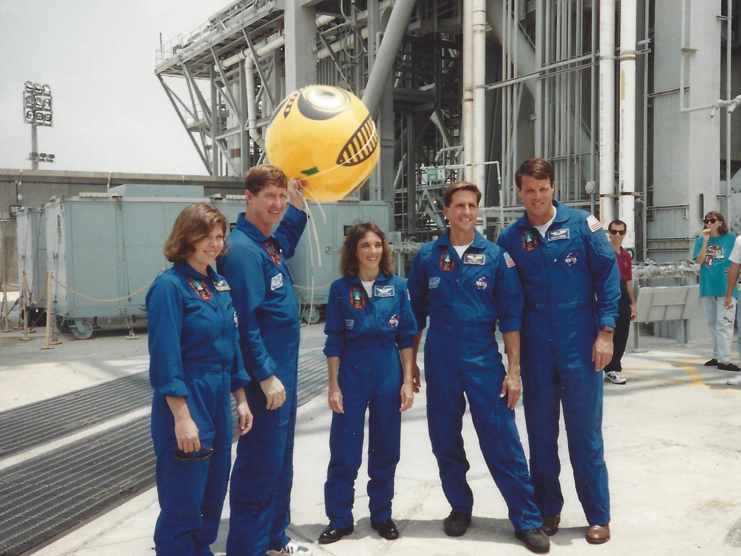  Crew holding predator-eye balloon to scare woodpeckers away (photo Don Thomas). 