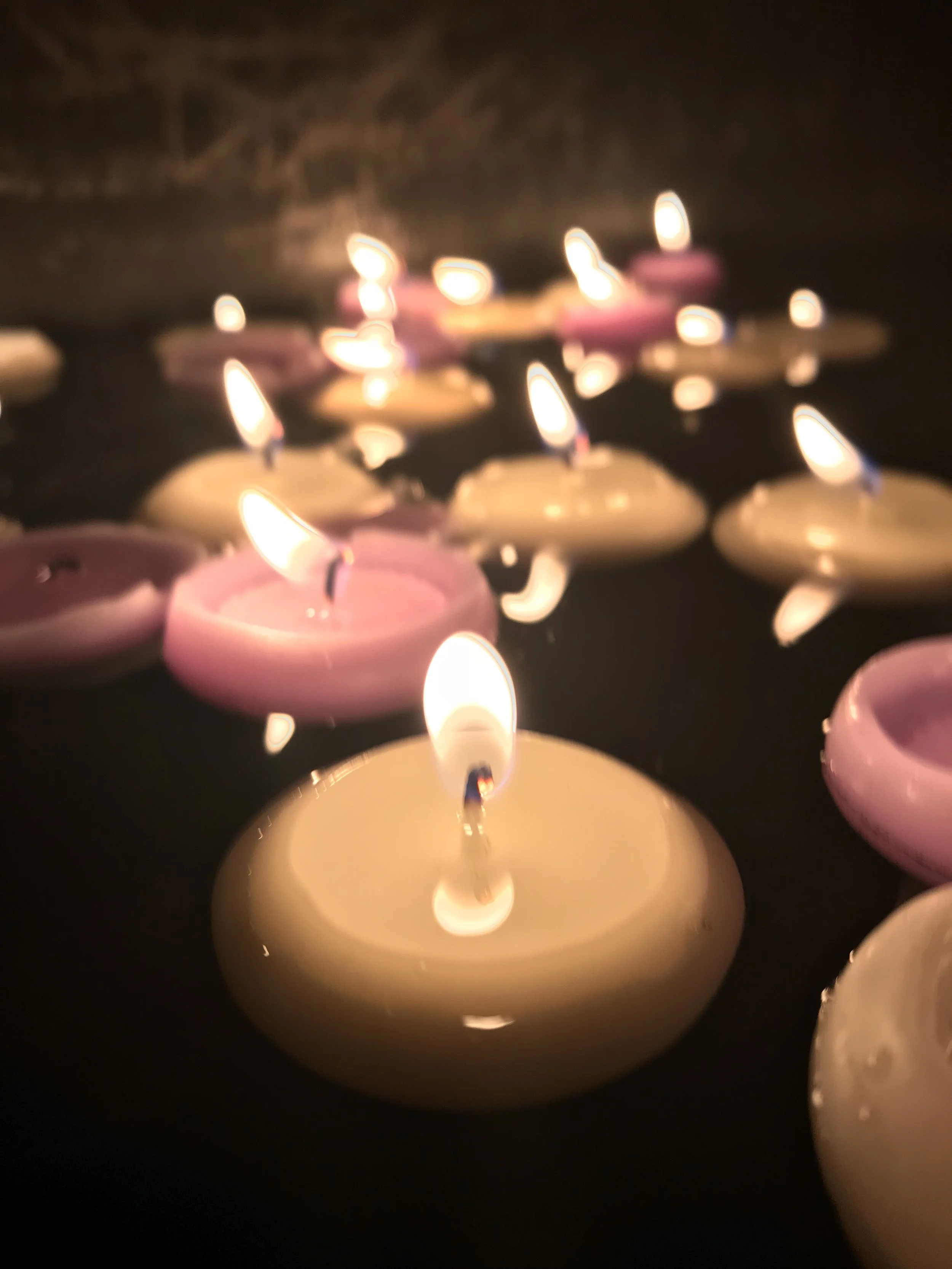 We lit candles for the things we've renounced (or need to renounce) in order to be with Jesus. And we floated them on the waters of the baptistery.