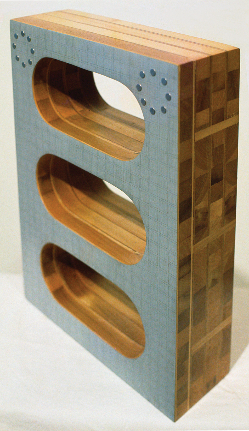 Figure 3. Marilyn Lerner, What Goes Around Comes Around , 1969. Laminated wood, acrylic paint, graphite pencil, and metal studs, 18” x 13” x 5”