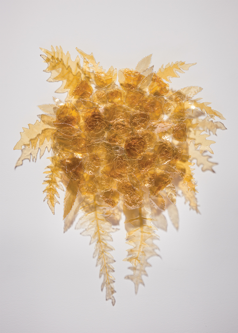 Christina P. Day, Cascade (One's one and only) , 2016. Found seat cover vinyl (naturally aged), mono-filament, wood. 24" x 28" x 1.75" Photo by Jaime Alvarez.