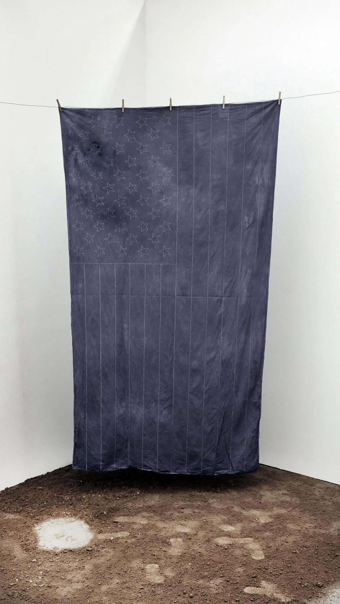 Ariel Jackson, All I See Is Blue , 2017. Top layer soil from the Bronx, muslin fabric, blue dye, clothespins, wire polyester thread, 72 x 108 inches.