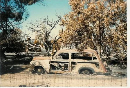 THE BURNED OUT "WOODY" station wagon after the 1985 New Life Fire. Avatar Meher Baba rode in this car when He visited Meher Mount on August 2, 1956. (Sam Ervin photo, 1985.)