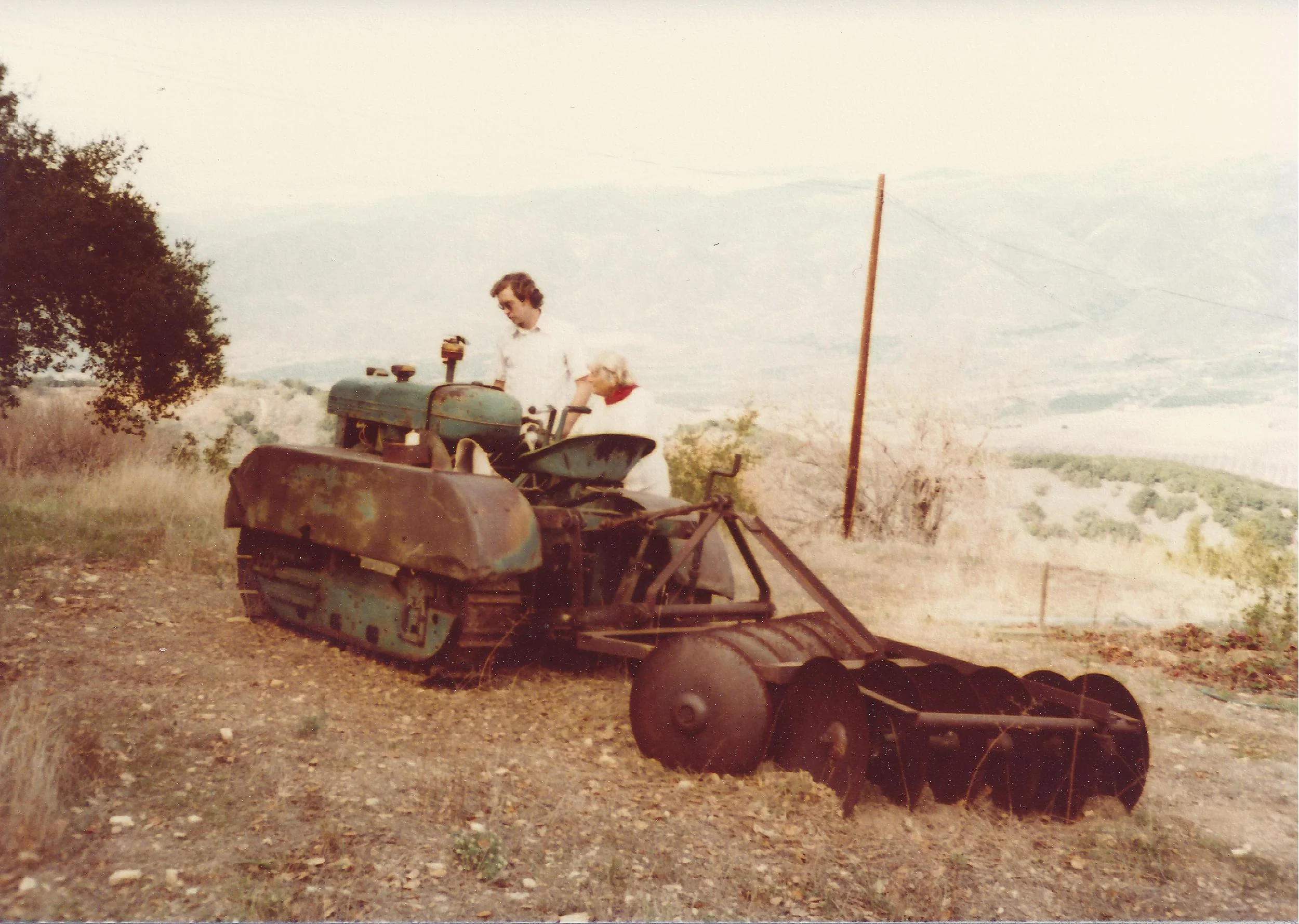 THE TRACTOR AGNES USED during the well adventure. Agnes Baron is discussing the working condition of the tractor in 1978 with a visitor. (Sam Ervin photo, 1978.)