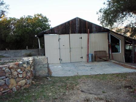THE "TEMPORARY" WORKSHOP was built with found materials sometime around 1986 and subsequently repaired to make it usable until a new Workshop could be built. To save money, Meher Mount did not insure it because it wasn't worth insuring or saving. (Margaret Magnus photo, 2010.)