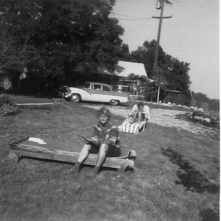 AGNES BARON (foreground) in a rare moment of relaxation. Unidentified woman in the background. They are in front of the farmhouse and garage. (Archive photo.)
