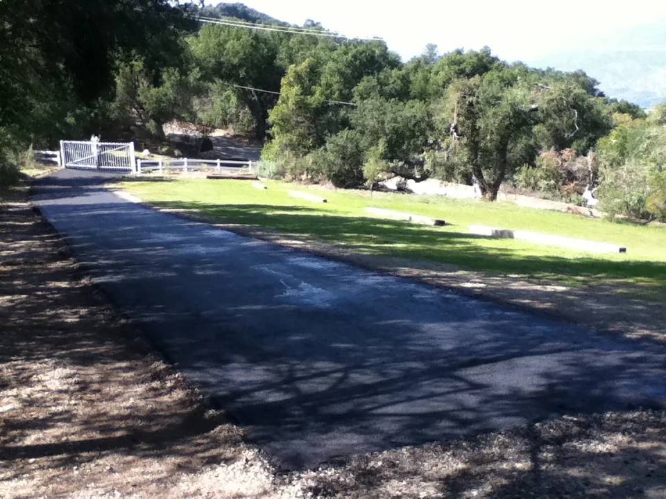 THE COMPLETED DRIVEWAY with new asphalt. (Leslie Bridger photo, March 2013.)