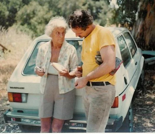 AGNES BARON writing instructions to Sam Ervin during a Silence Day "Work Party" at Meher Mount in the late 1970s. (Margaret Magnus photo.)