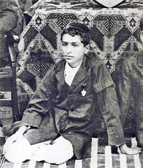 MEHER BABA as a young boy in 1910 on the St. Vincent's school cricket team in Pune, India. From The Awakener's special photo issue, 1971 .