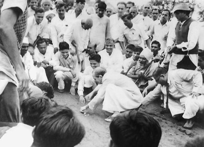 AVATAR MEHER BABA playing marbles with His disciples and followers.