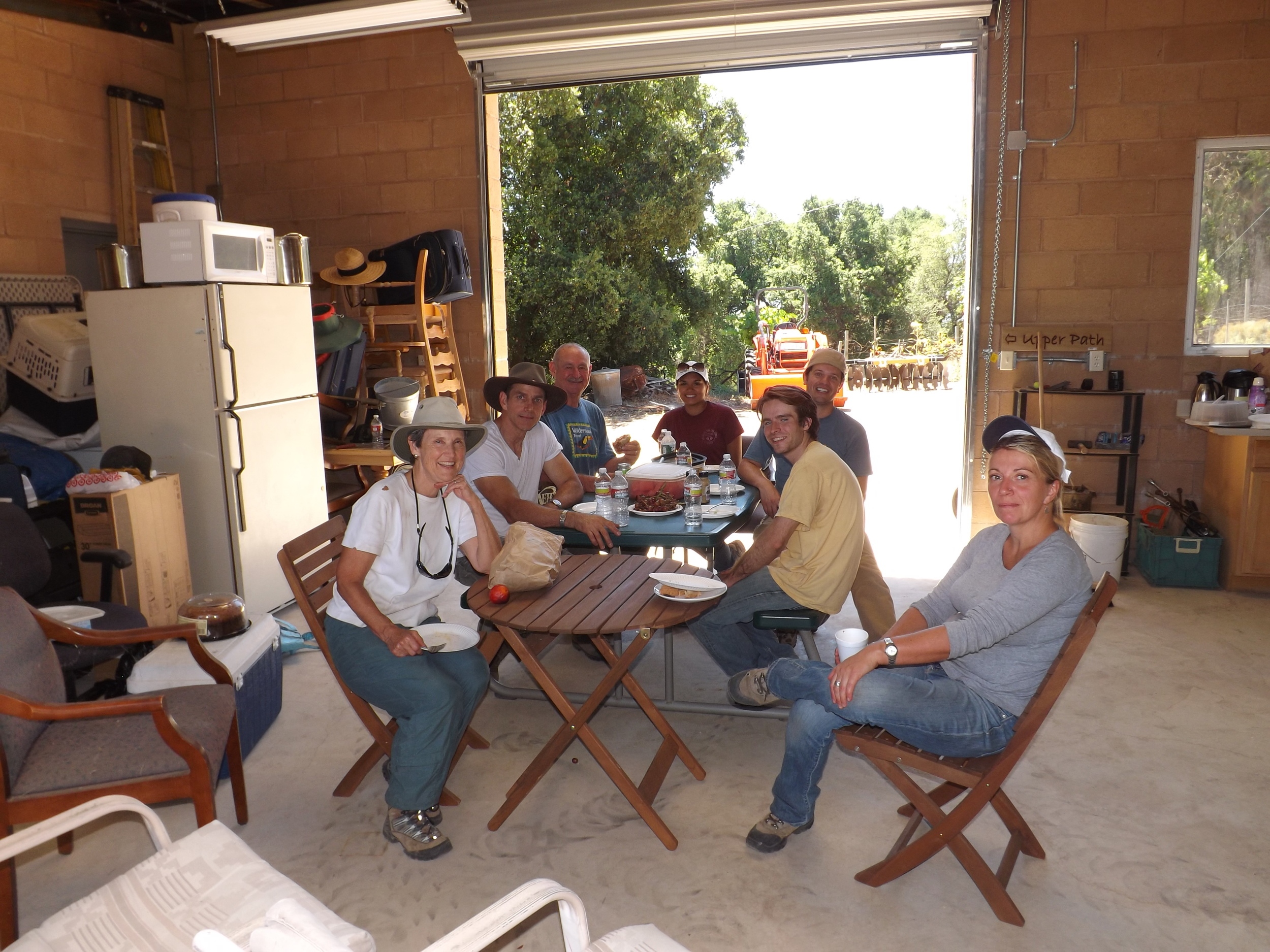 TAKING A LUNCH BREAK in the Workshop out of the July sun after working all morning on removing Yellow Starthistle. (Left to right): Margaret Magnus, Dusttin Paren, Sam Ervin, Michelle Choug, Josh McGill, Ian Dibble, and Samantha Bridger. (Photo: Leslie Bridger, 2012)
