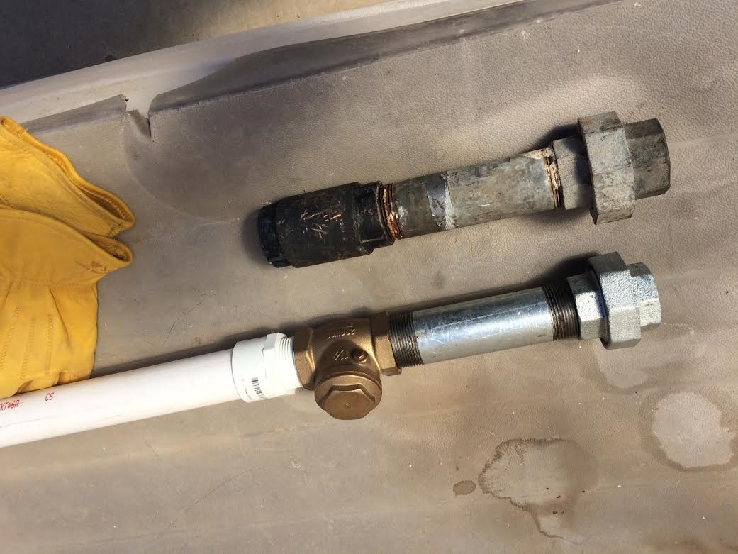 THE NEW check valve and PVC pipe were the first step in trying to fix the leaking well. (Photo: Buzz Glasky, 2016)