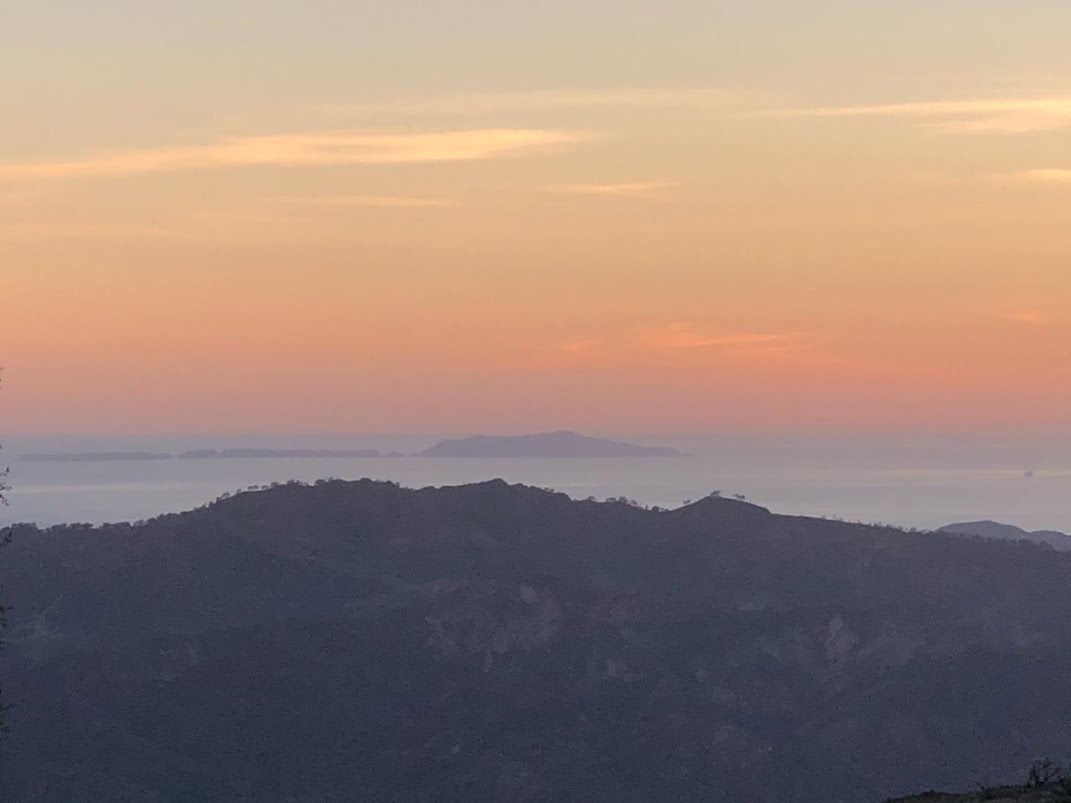 A SUNSET over the Pacific Ocean as seen from Avatar's Point and Baba's Tree marks the conclusion of a very successful workday at Meher Mount. (Photo: Bing Heckman, January 28, 2010)