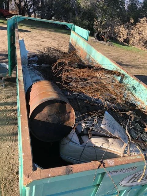 A DUMPSTER FULL OF DEBRIS from the January 2018 Fire Cleanup Day. (Photo: Bing Heckman)