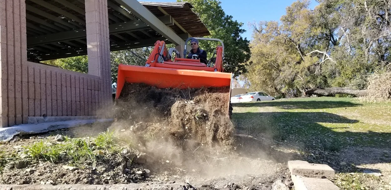 RAY JOHNSTON moving dirt from elsewhere on the property to fill in the semi-hazardous hole near the Topa Topa Patio. (Photo: Margaret Magnus, February 21, 2018)