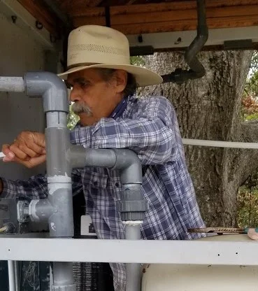 RUDY DURAN brought his water system expertise and changed the filters on the water treatment system. (Photo: Margaret Magnus, May 20, 2018)