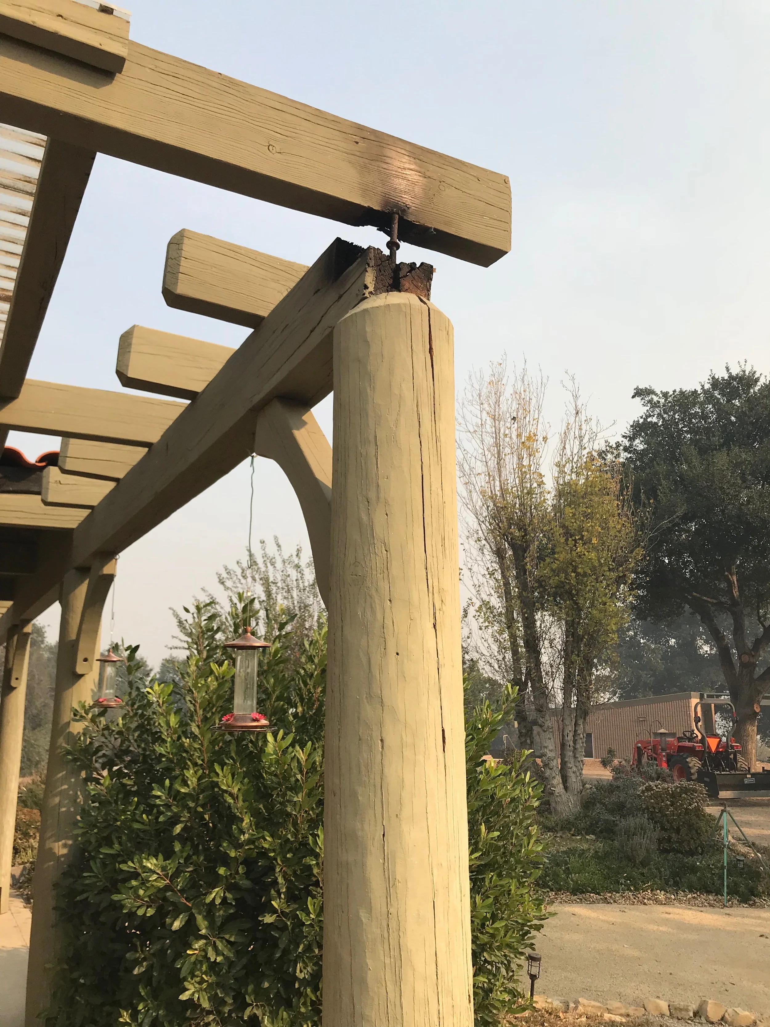 BURNED CORNER of the trellis for the Visitor Center/Caretaker Quarters at Meher Mount following the December 2017 Thomas Fire. (Photo: Buzz Glasky, December 2017)
