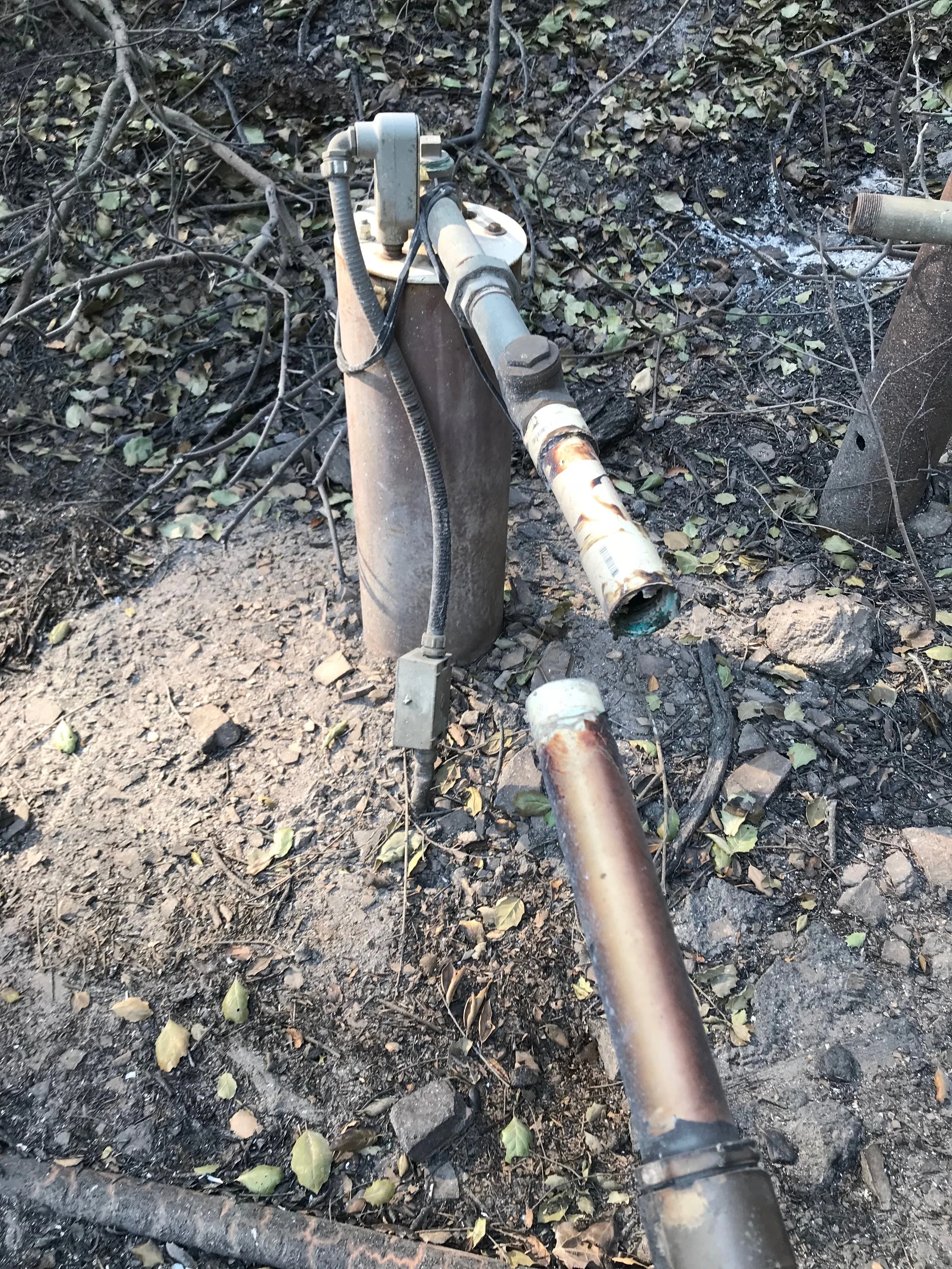 BURNED PIPE is part of the fire damage at the well head at Meher Mount. The electrical also needed to be replaced so that water could be pumped to the reservoir and then to the Visitor Center/Caretaker Quarters. (Photo: Buzz Glasky, December 2017)
