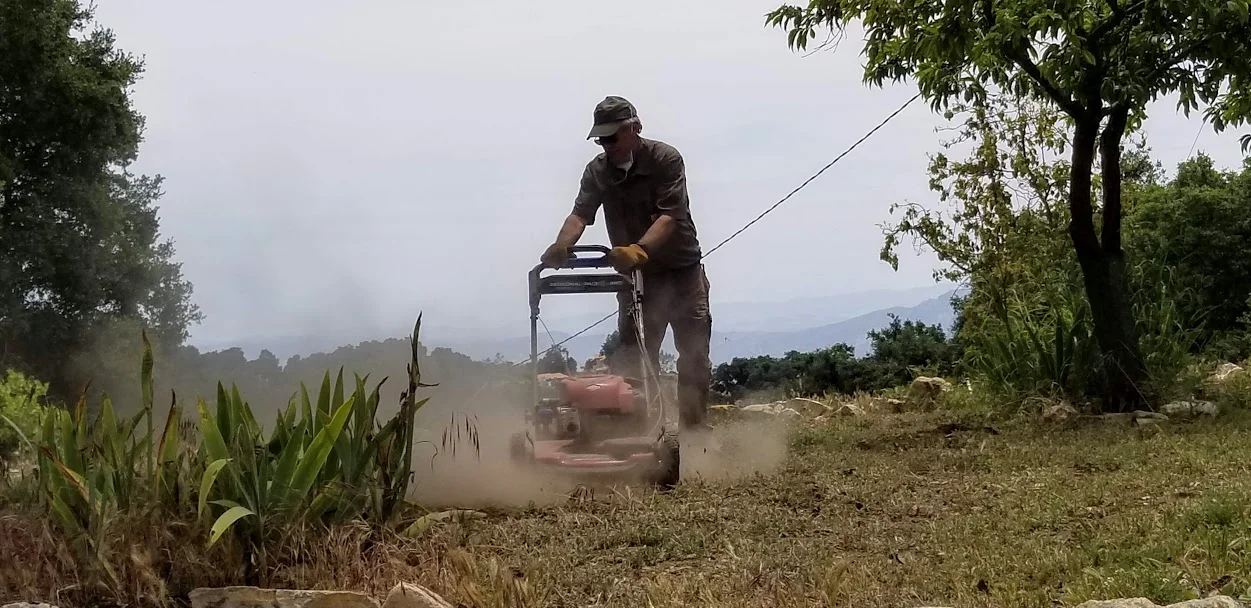 BING HECKMAN is mowing the grassy area near the Visitor Center. (Photo: Margaret Magnus, May 18, 2019)