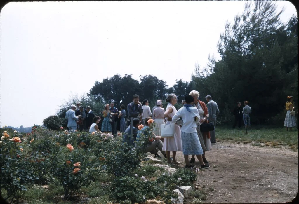 AT DAY’S END on August 2, 1956, visiting Meher Mount with Avatar Meher Baba. Margaret Craske is in the foreground carrying the white purse. She is talking with Kitty Davy and an unidentified woman. (Photo: Darwin Shaw, ©Meher Nazar Publications) To help identify anyone in the photograph, please contact Meher Mount.