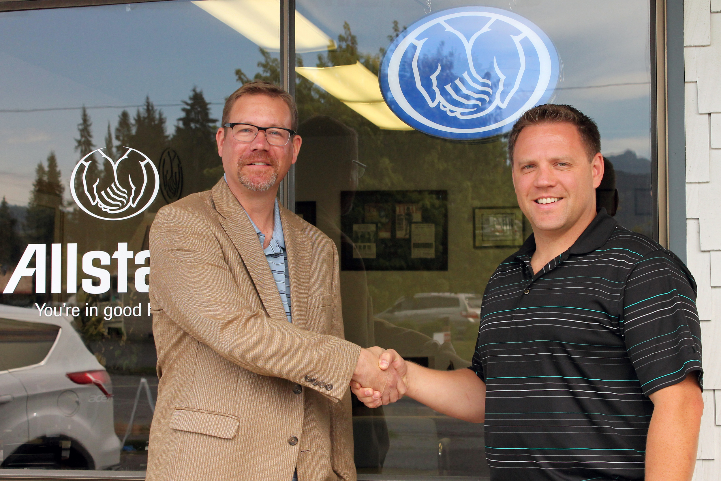 Jorgen Goller, left, presenting Matt Elwood, right, with the Allstate Honor Ring for his outstanding efforts in 2014. 