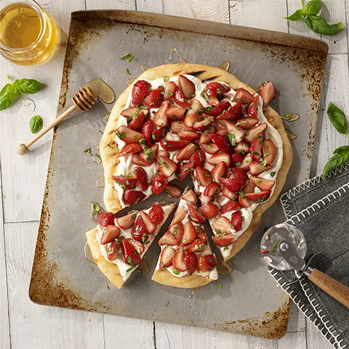 Pizza and strawberries, count me in! This dessert is perfect for a summer cookout with grilled pizza crust, cream cheese spread, and fresh strawberries tossed with honey and basil. YUM! Photography and recipe found at: readyseteat