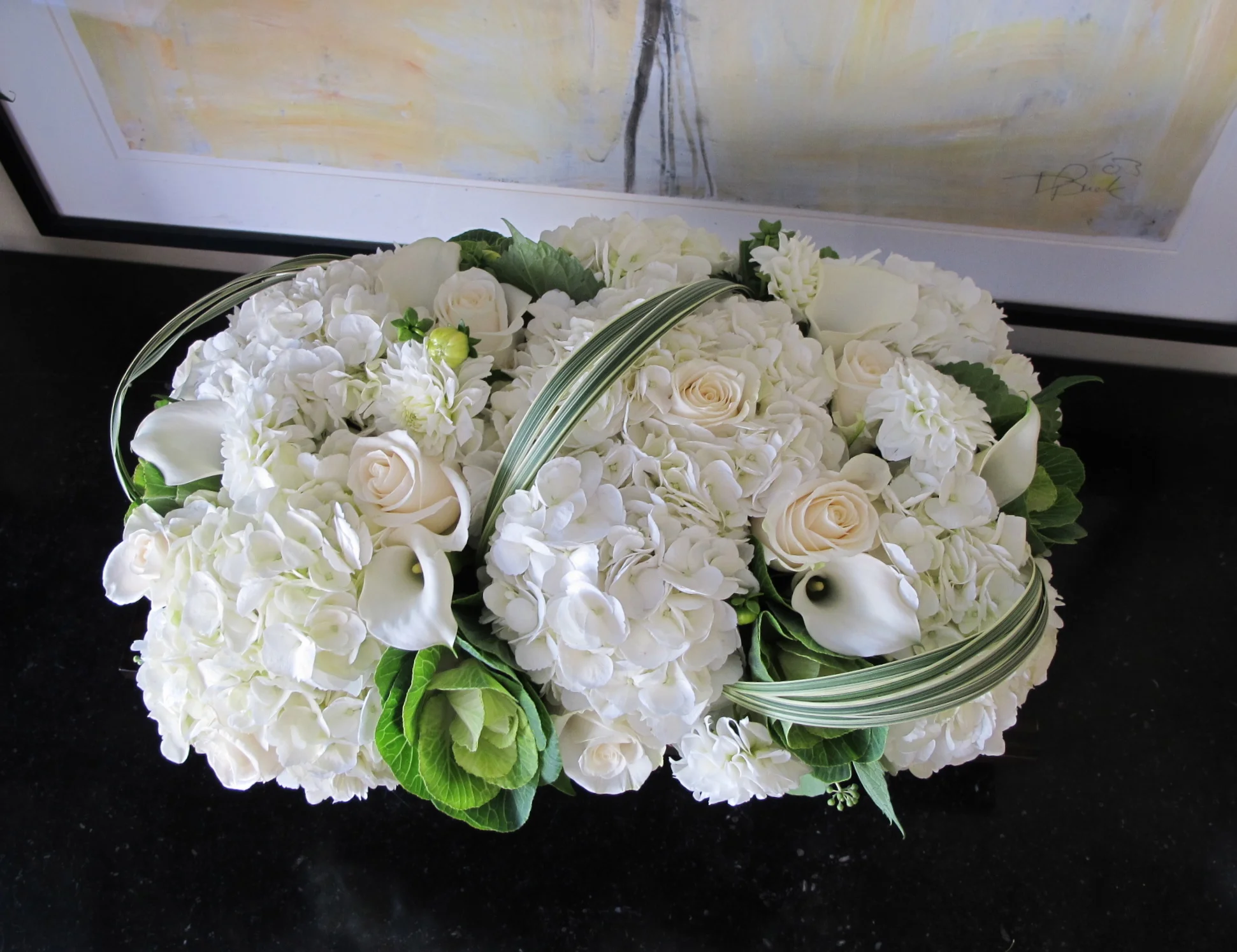 White hydrangea, roses with accents of brassica