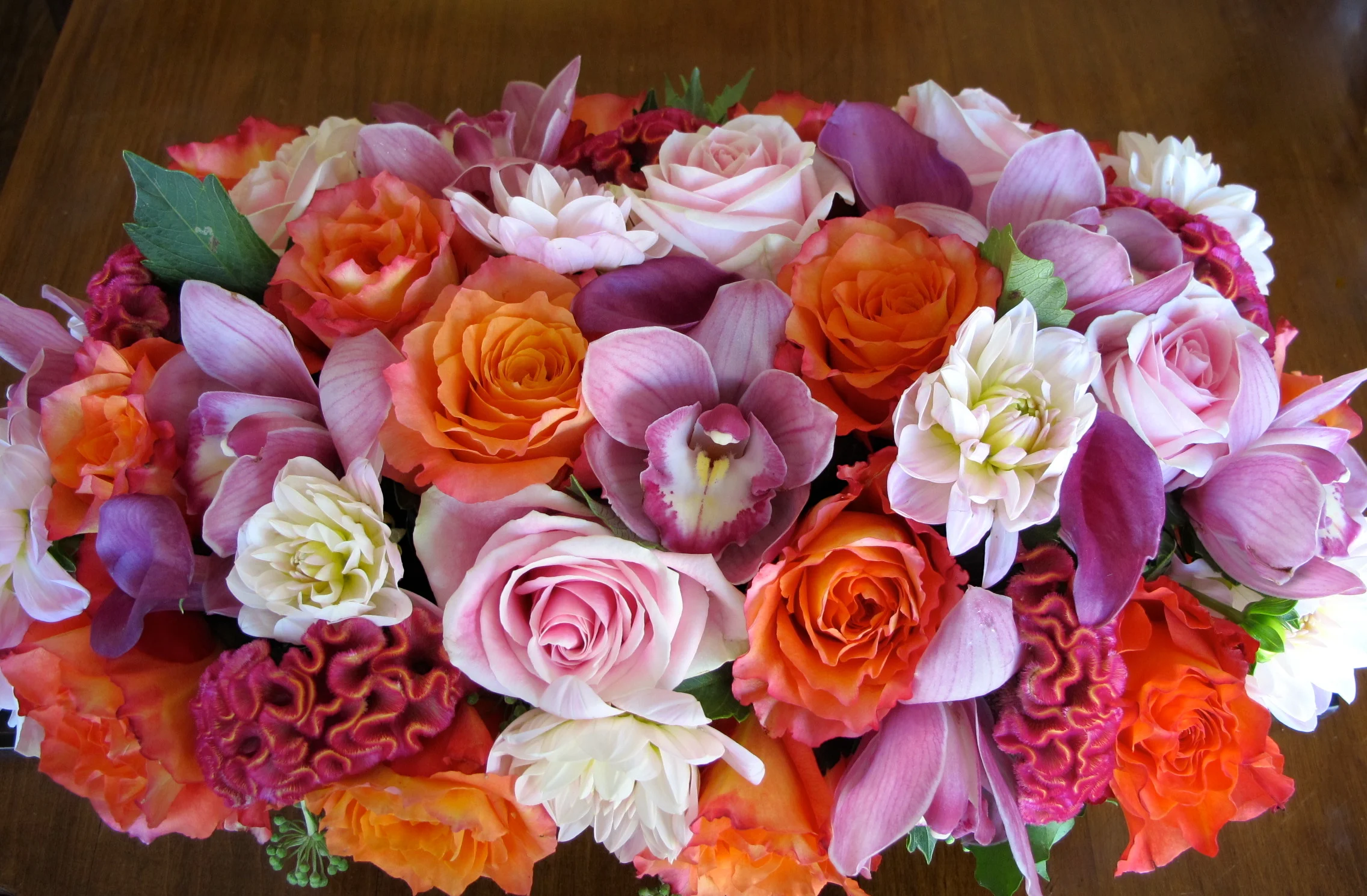 Roses, callas,cymbidium orchids with white dahlias