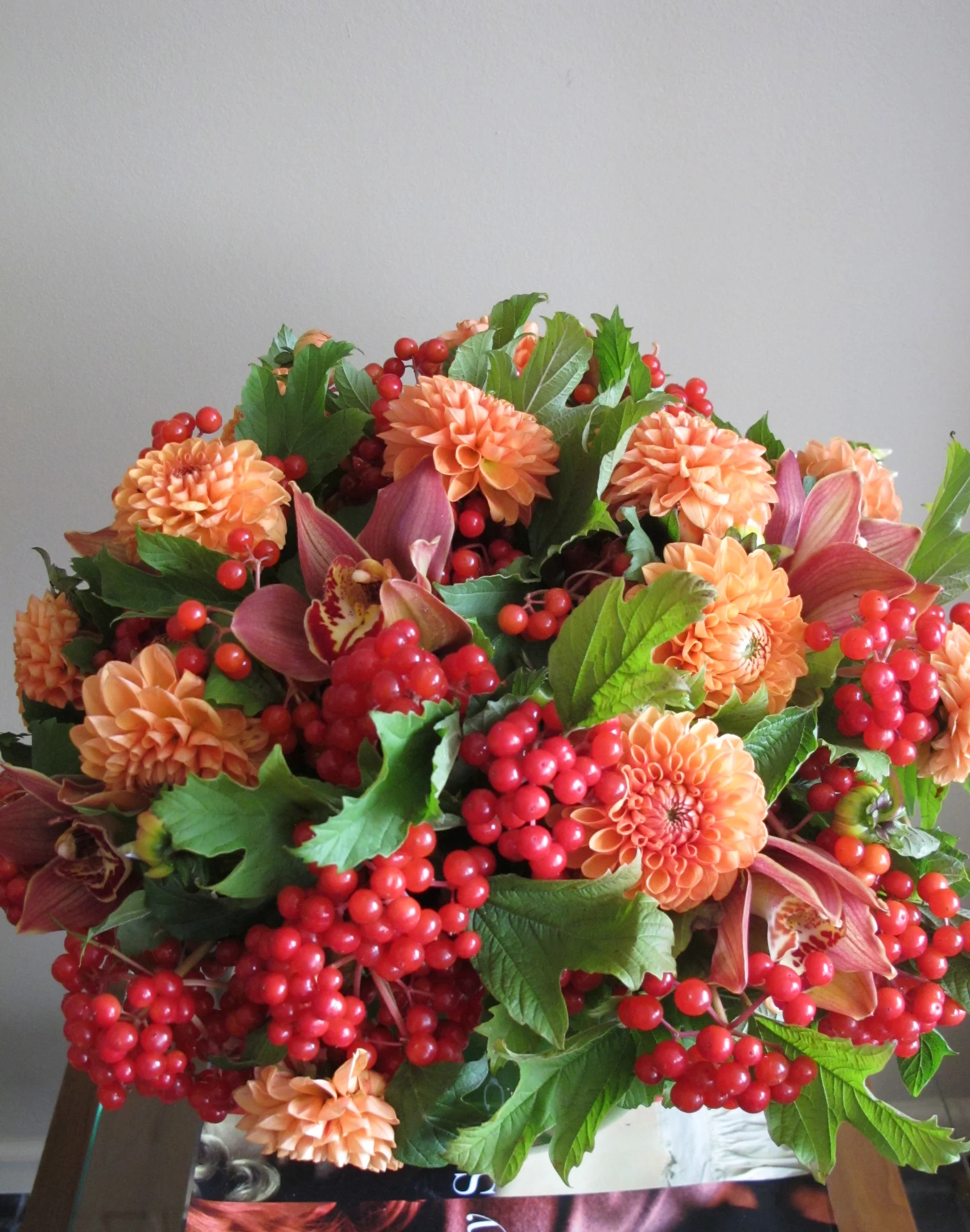 dahlias,cymbidium orchids with viburnum berries