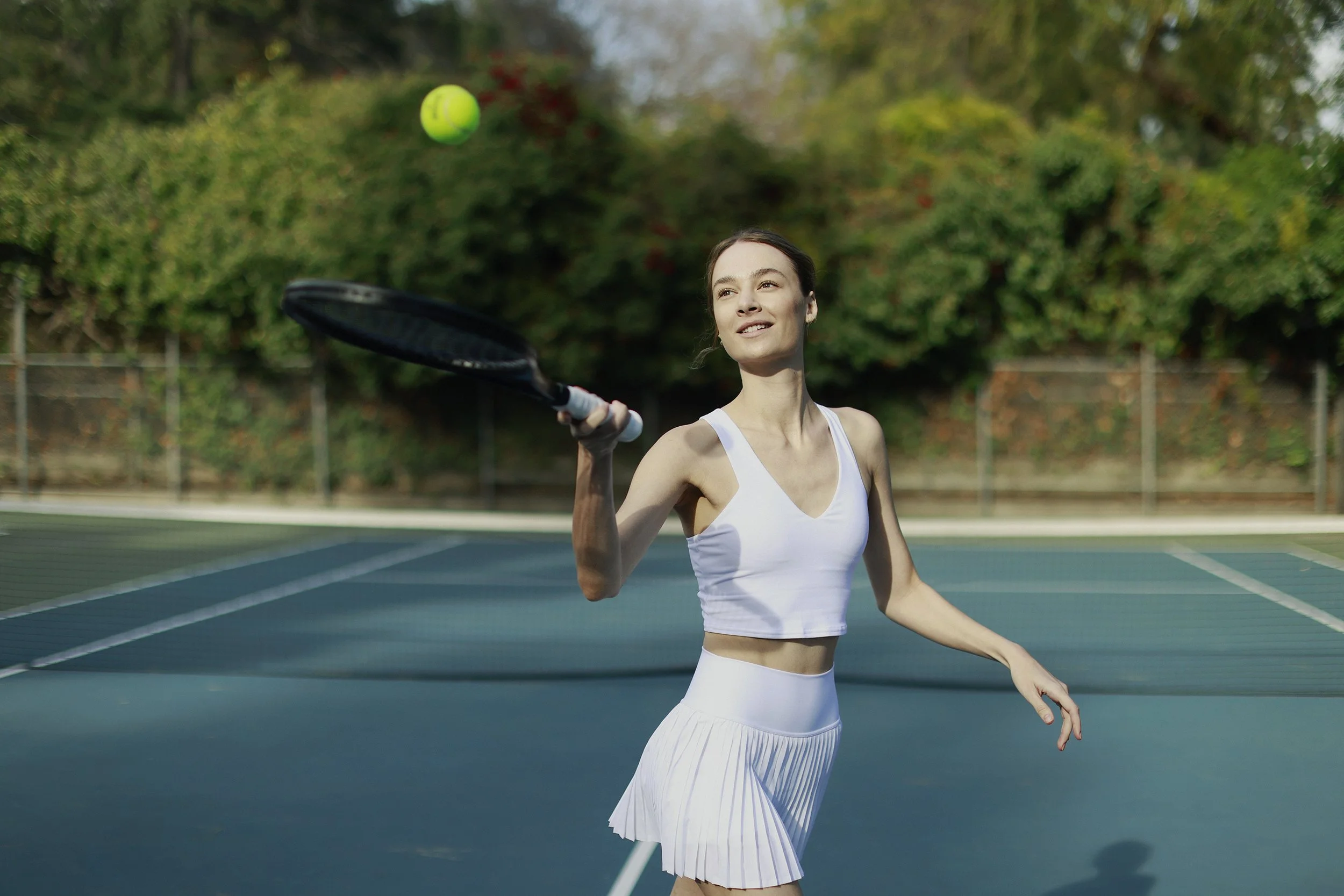 alo-tennis-skirt-white-lifestyle-patrick-fraser-studio_THL9630.jpg