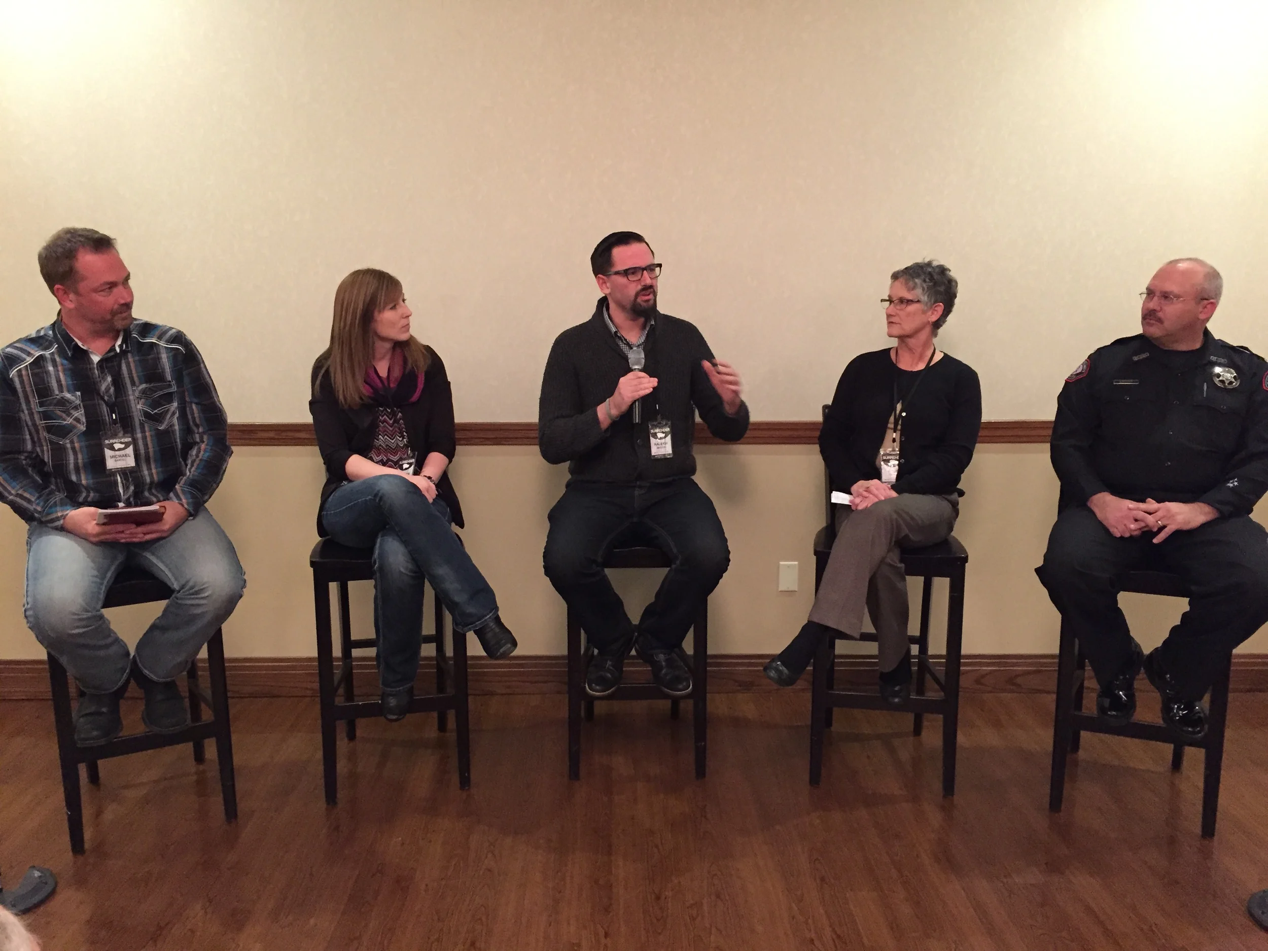 Raleigh Sadler in the center speaking on a panel concerning the role of the church in fight human trafficking in Springfield, Missouri .