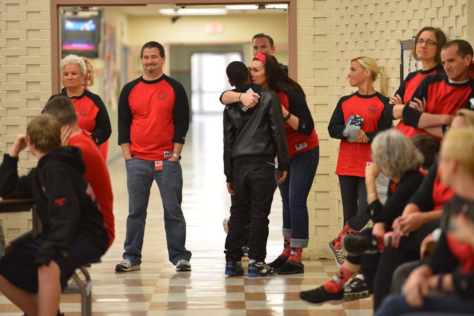 A Whitman Middle School teacher hugs a student after receiving a gesture of appreciation from him during the assembly.
