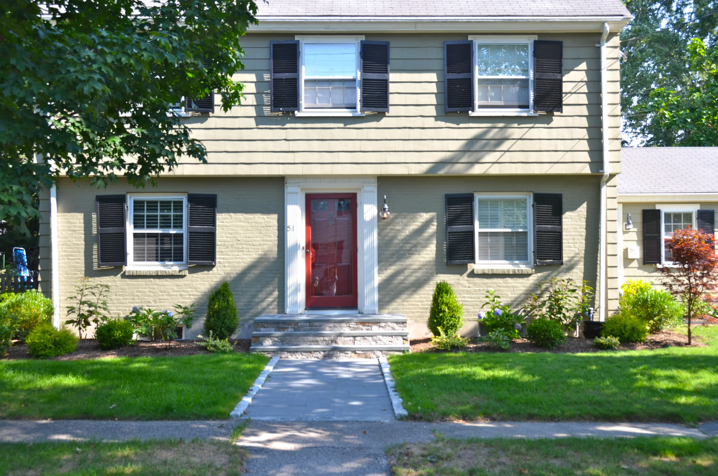 This is the home after 6 weeks. The plantings are growing, and the new grass is lush.
